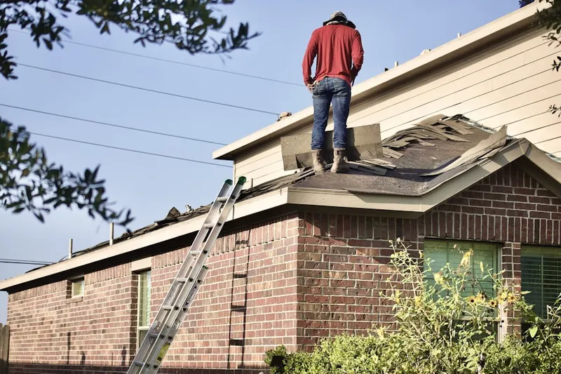 Professional roofer working on a residential roof in Mora